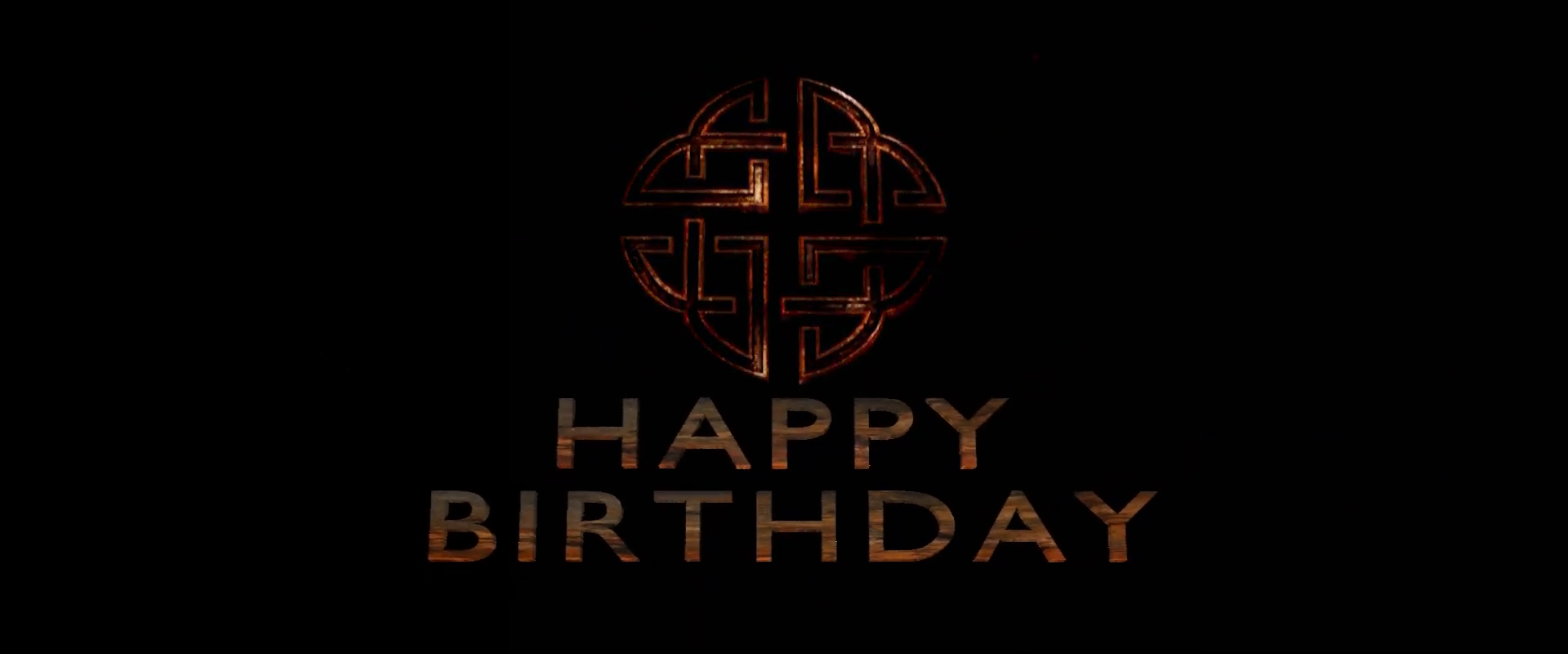 Decorative 'Happy Birthday' text with intricate design on a black background